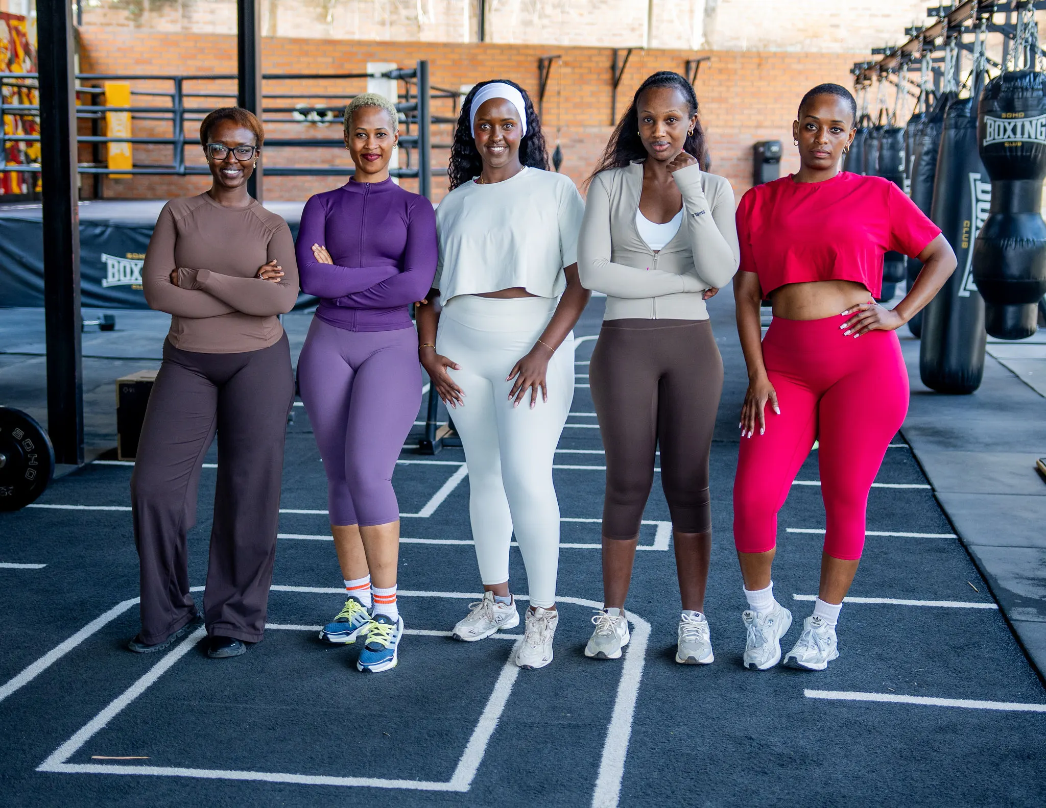 Five women in Shield activewear standing together at the gym
