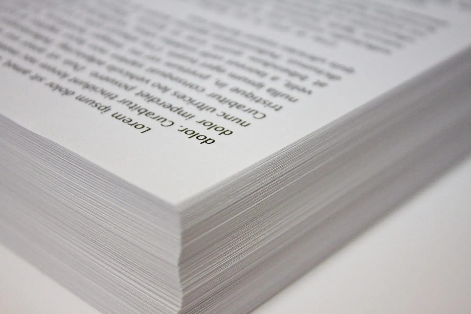 A tall stack of freshly printed sheets