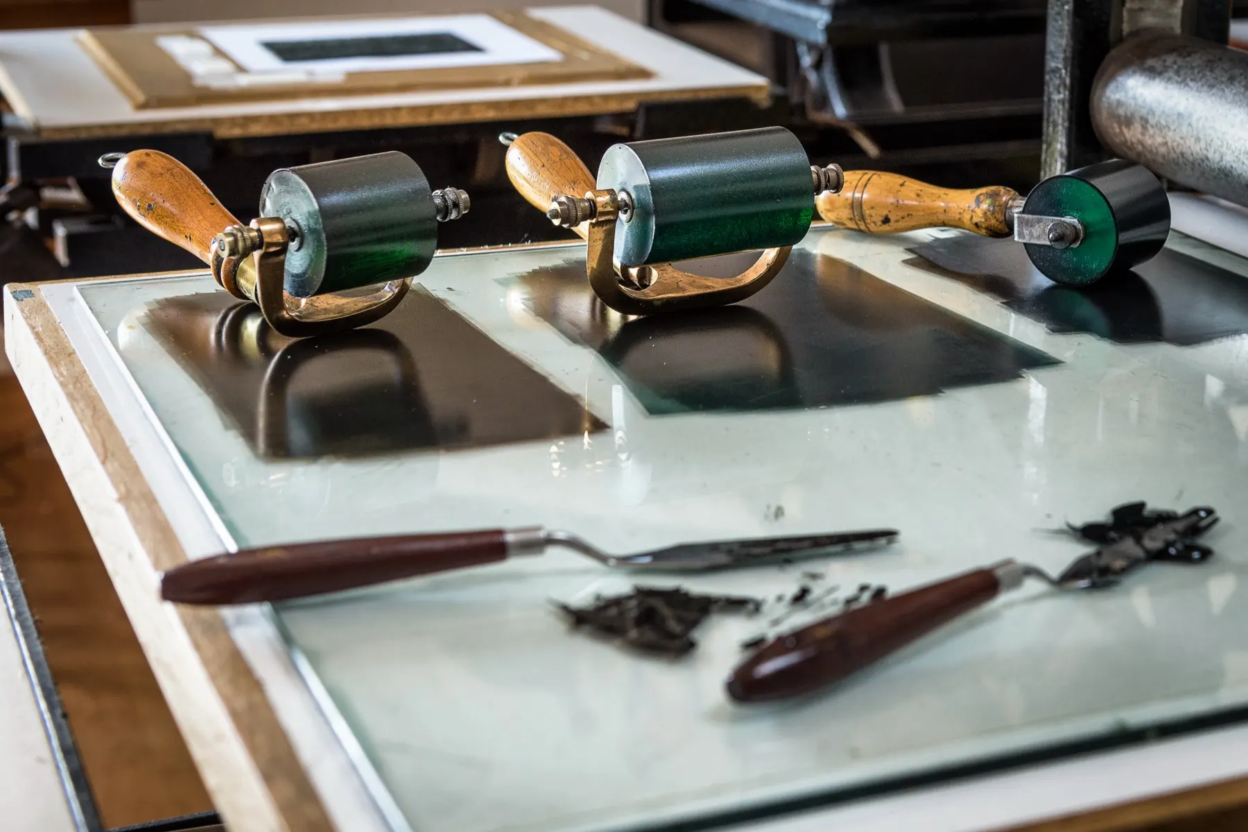 Ink rollers and palette knives on the print bench